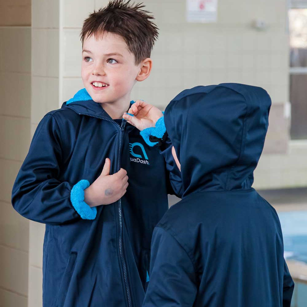 Boy wearing swim parka after swimming