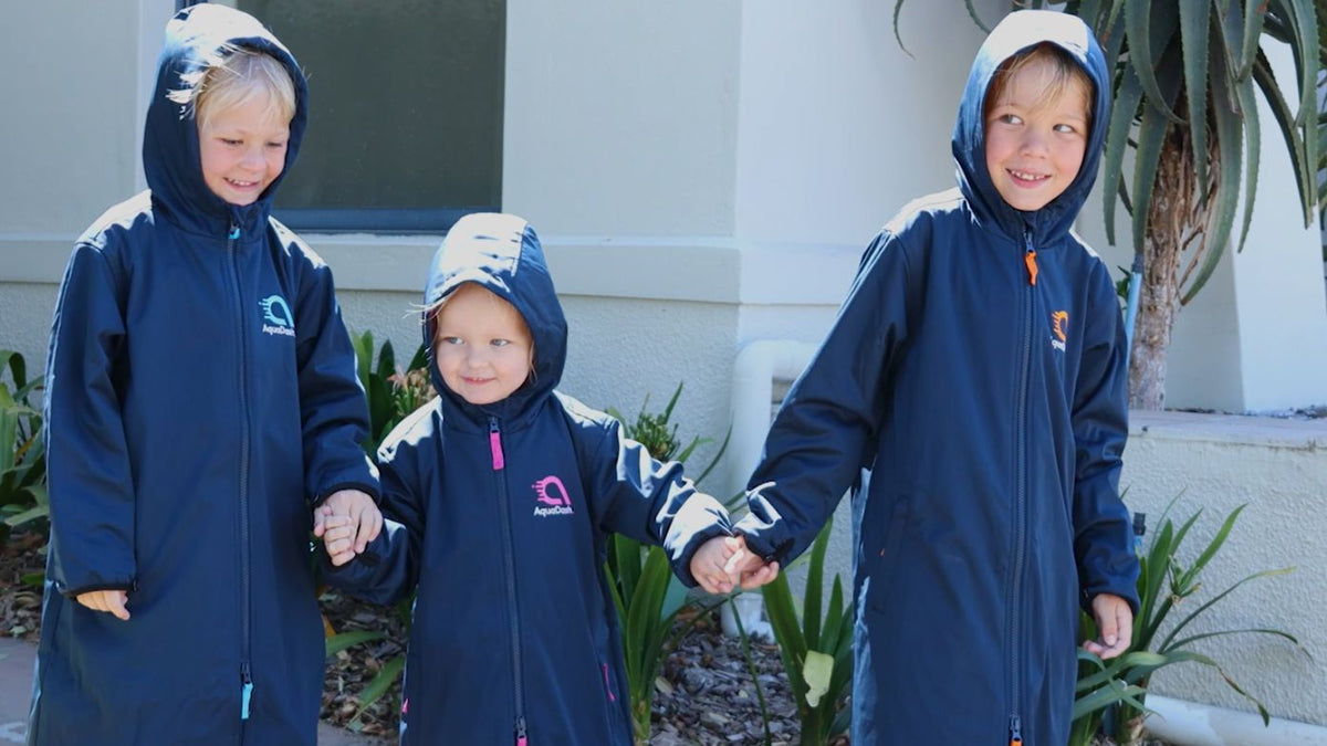 Kids in swim parkas walking from pool to car